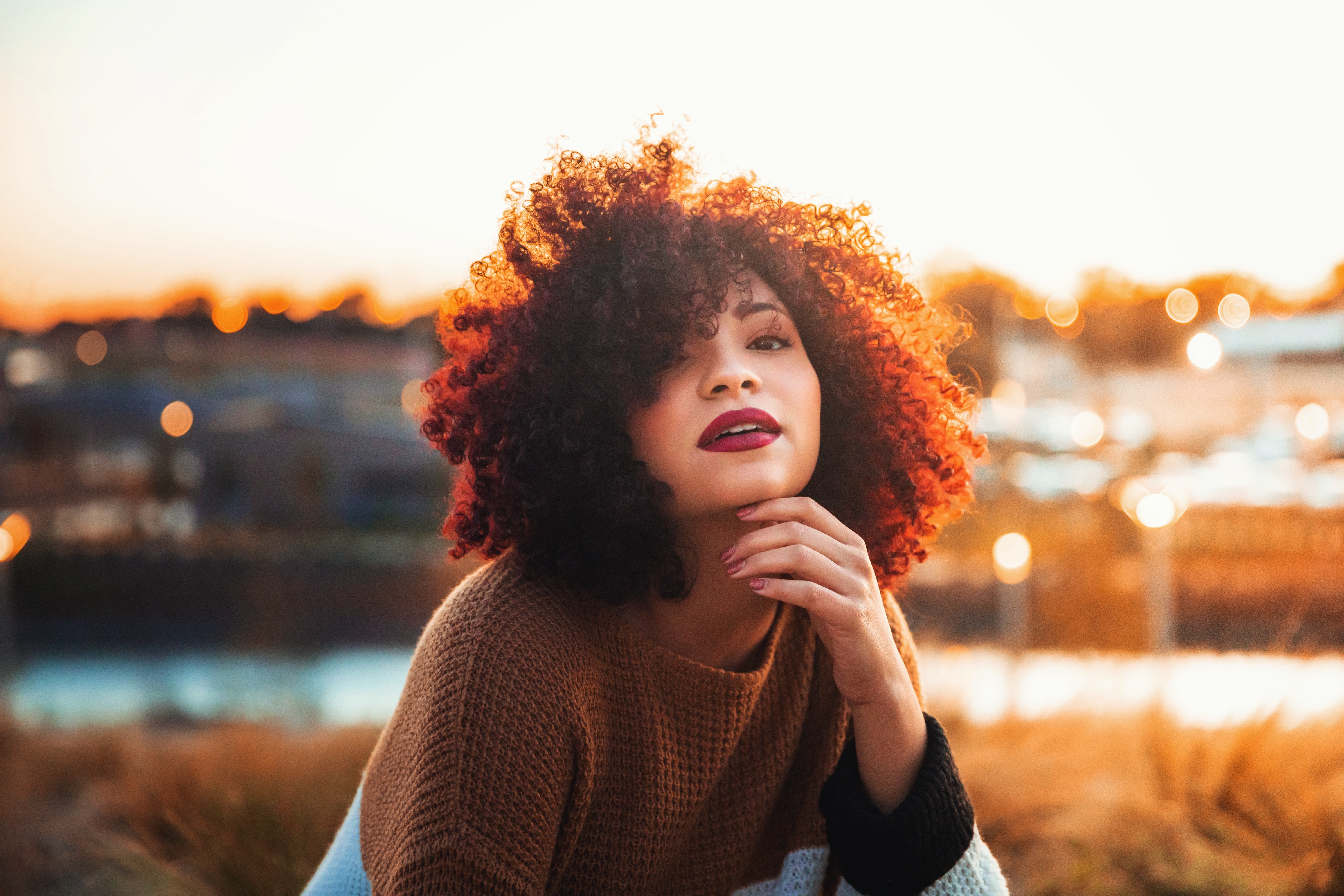 Founder of Curl Power sitting with curly hair